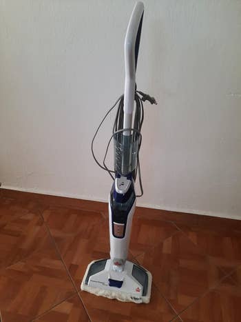 Reviewer's upright steam mop for floor cleaning with a detachable handheld steamer, corded, on tiled floor