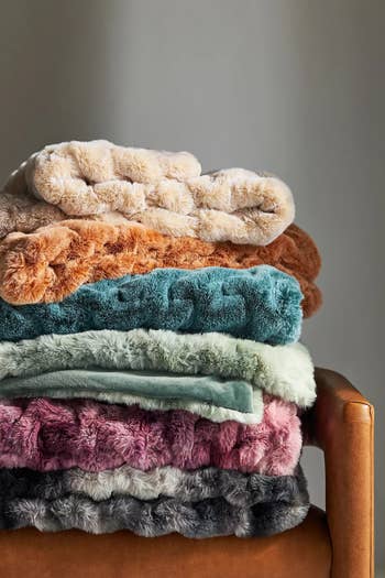 a stack of the blankets in different colors