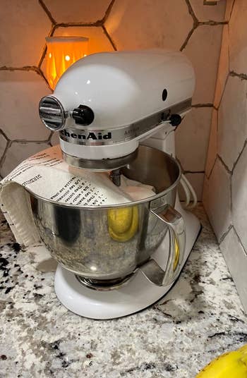 the mixer mat visible just slightly under a reviewer's white kitchenaid