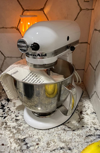 the mixer mat visible just slightly under a reviewer's white kitchenaid