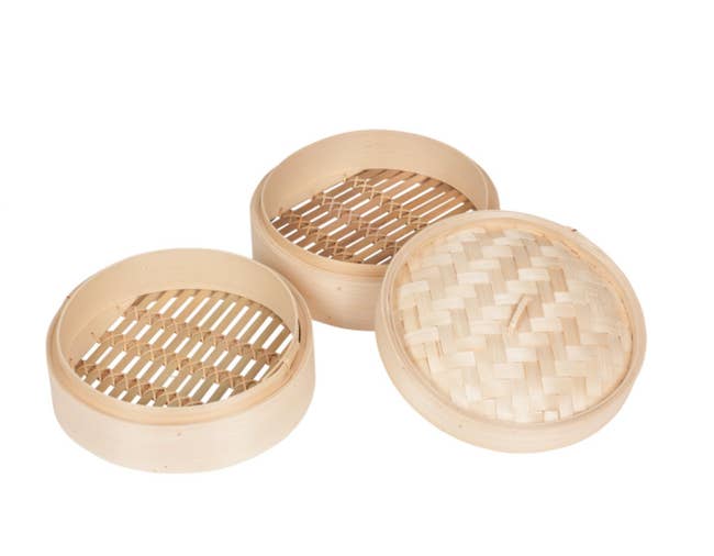 Two bamboo steamers, one bamboo lid