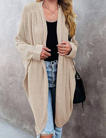 a model wearing the cardigan in cream 