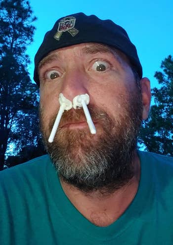 reviewer with the nose wax sticks in their nose
