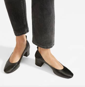 model wearing black leather heels