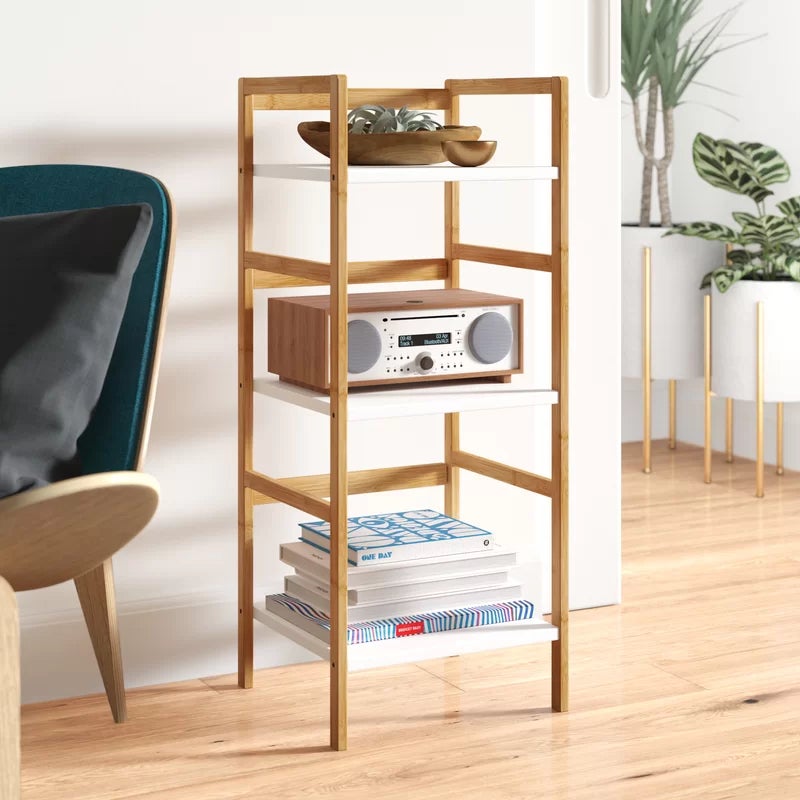 the 3-tier solid wood bookshelf with books, plants, and a stereo displayed on it