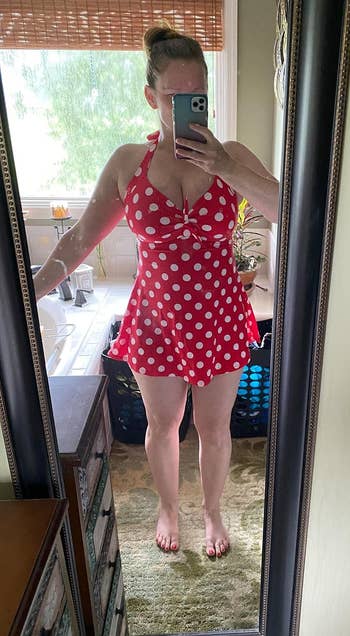 Person taking a reflector selfie successful a polka dot swimsuit, lasting successful a cozy chamber oregon bath setting