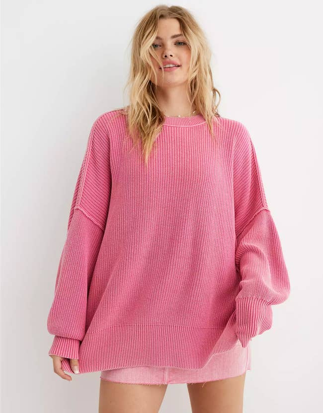 model wearing the pink oversized sweater with a pink mini skirt