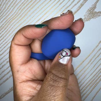 Hand wearing blue finger vibrator