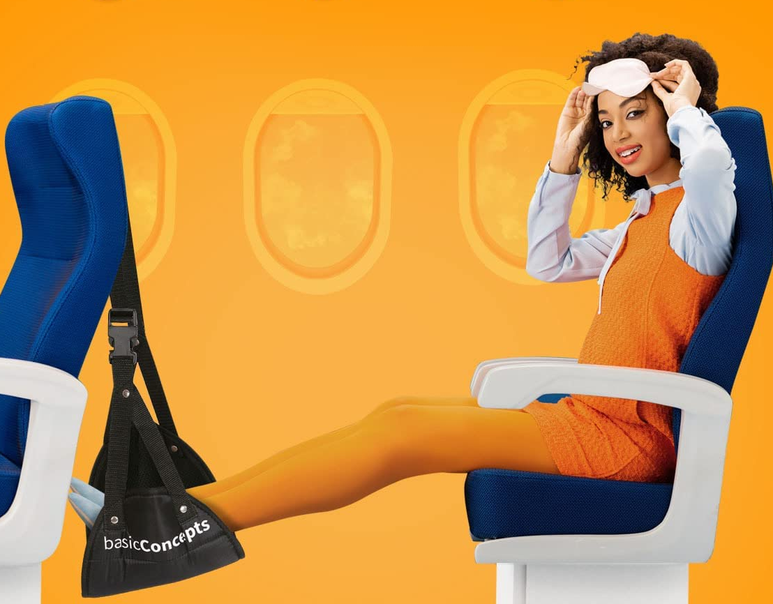 Model using the foot hammock while sitting on an airplane seat