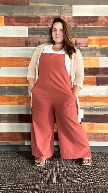 plus-size reviewer wearing the red clay version over a t-shirt and with a cardigan