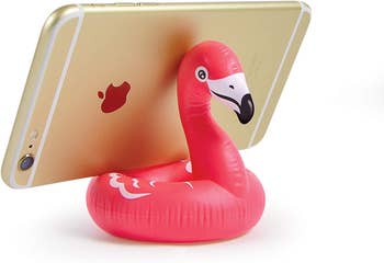 phone stand that looks like a flamingo pool float holding phone horizontally