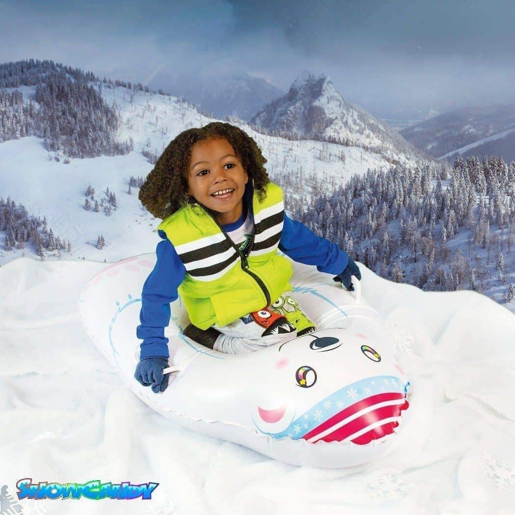 presents 3 year olds a child model sitting atop inflatable polar bear snow toy