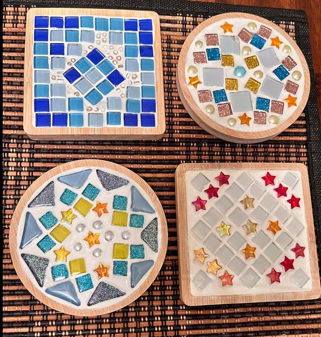 Four different sets of decorative ceramic coasters featuring geometric and star patterns made from colorful tiles and beads, displayed on a woven placemat