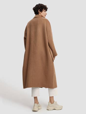 back view of a different model wearing the coat in light brown