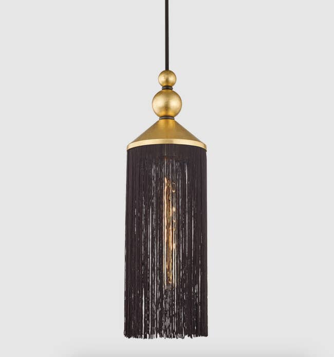 Elegant pendant light with a tassel design and central bulb, suitable for adding a chic touch to interiors