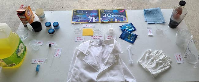 reviewer image of the magic kit laid out on a surface, including a lab coat, gloves, and instructions