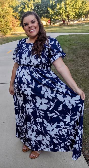 Reviewer in a navy and white floral maxi dress with short puffy sleeves and a shirred top 