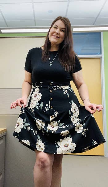 Image of reviewer wearing black floral dress