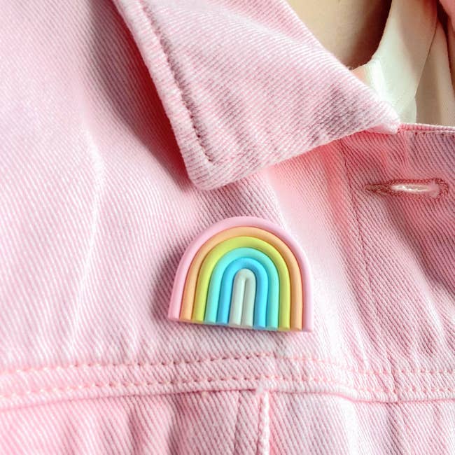 the pastel pink, orange, yellow, blue, and white pin on a pink jean jacket