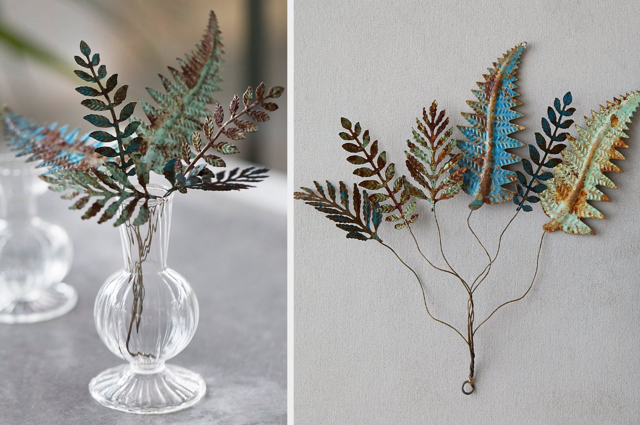 Iron stemmed leafs inside of a glass vase on a gray table, products wrapped and laid flat on a gray background