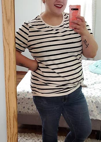 a reviewer shows a closeup of the black and white striped tee