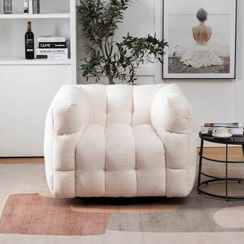 white tufted armchair