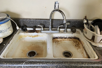a reviewer's sink looking rusted and dirty
