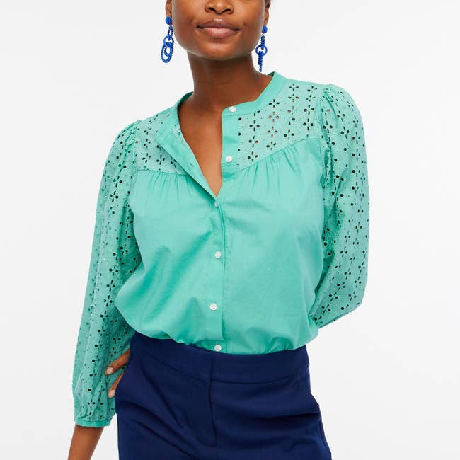 model in green three quarter sleeve button front top with eyelet sleeves and yoke
