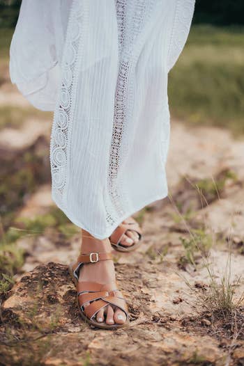 person walking with the brownish  sandals