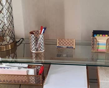 a reviewer's desk with many of the gold organizers on it