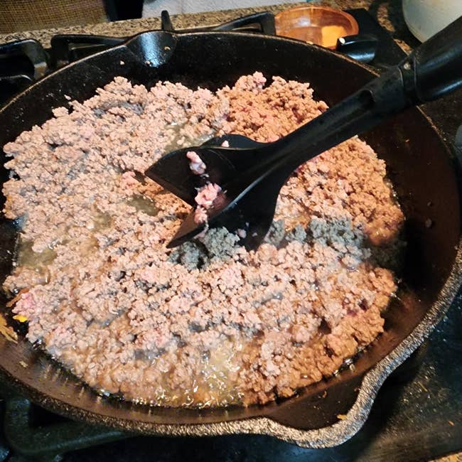 Ground nutrient   cooking successful  a skillet, stirred with a spatula