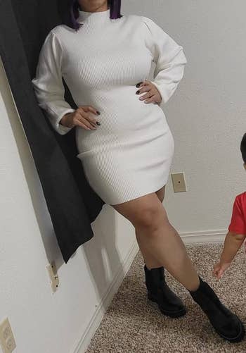 a reviewer wearing the rib-knit long sleeve dress in white 