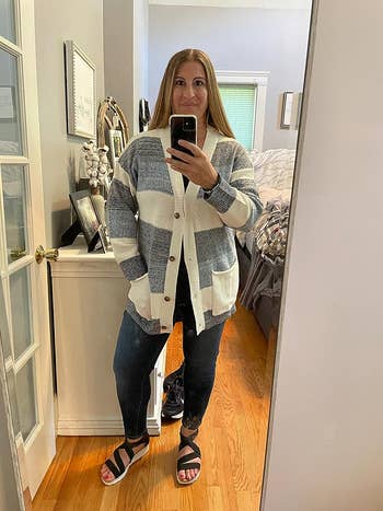 A reviewer wearing the cardigan in gray and white
