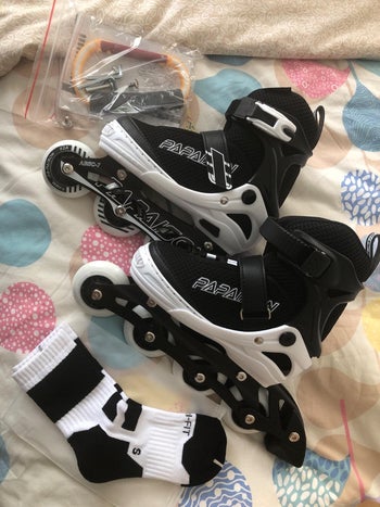 Reviewer image of the black and white socks, skates, and handle