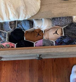 Organized drawer with assorted socks in geometrical dividers
