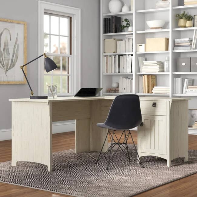 a white wood l-shaped desk