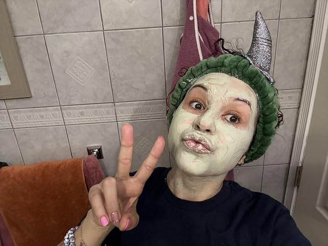 Person with clay look   mask, wearing a headband with pointy ears, gives a bid    motion   successful  the bathroom