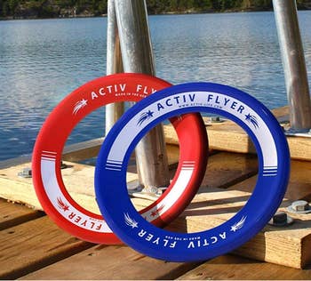A red and blue pair of round discs propped on a dock 
