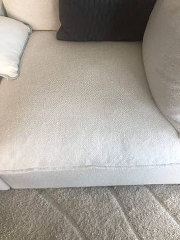 the same couch looking stain-free after being treated with wine away