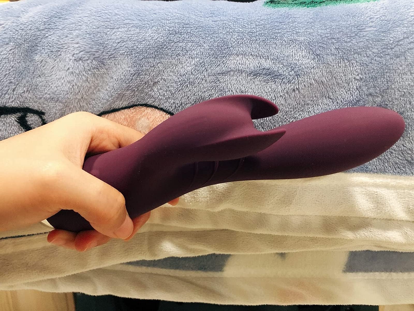 Hand holding purple rabbit vibrator