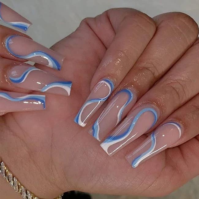 model's hand with abstract wavy press on nails
