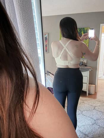 A reviewer showing the bra from the back