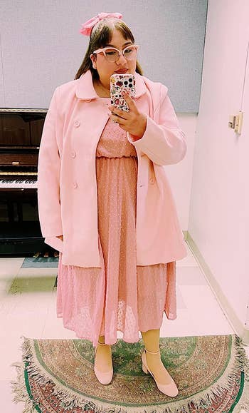 reviewer in a pink coat