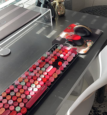 reviewer's red keyboard and mouse set on a desk