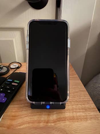reviewer photo of iPhone charging on Anker stand