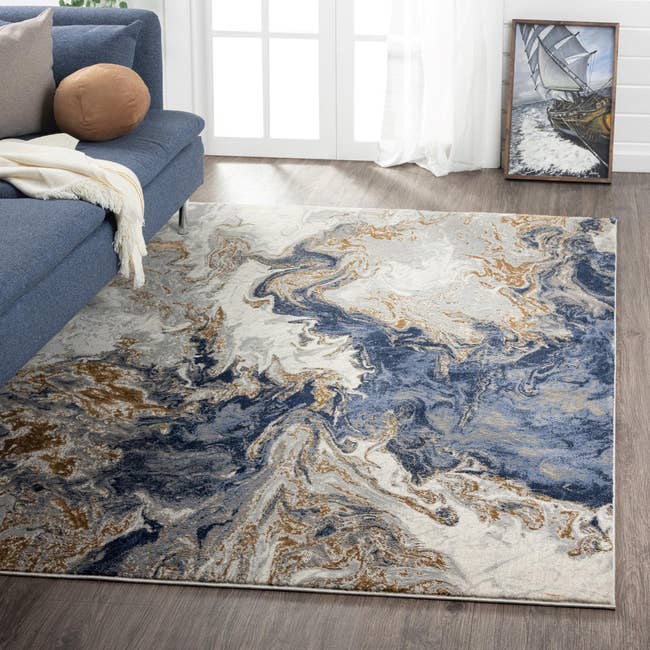 the blue marble-inspired area rug in a living room