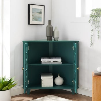 an open teal accent corner cabinet
