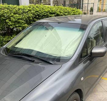 Car parked with windshield sunshade successful place, protecting the interior from vigor and prima damage