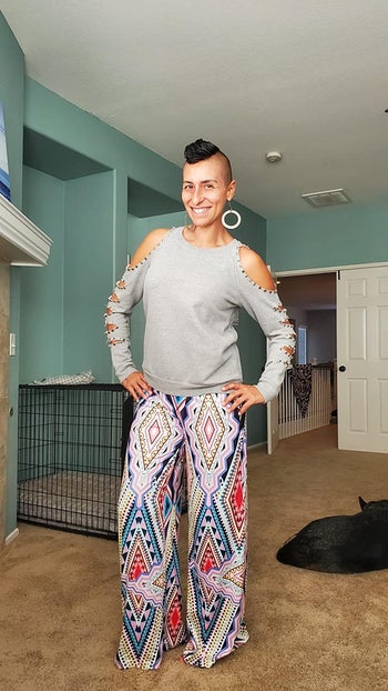 reviewer photo wearing tribal print palazzo pants, standing in carpeted room