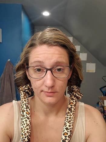 reviewer wearing the cheetah curling rod with their hair wrapped around